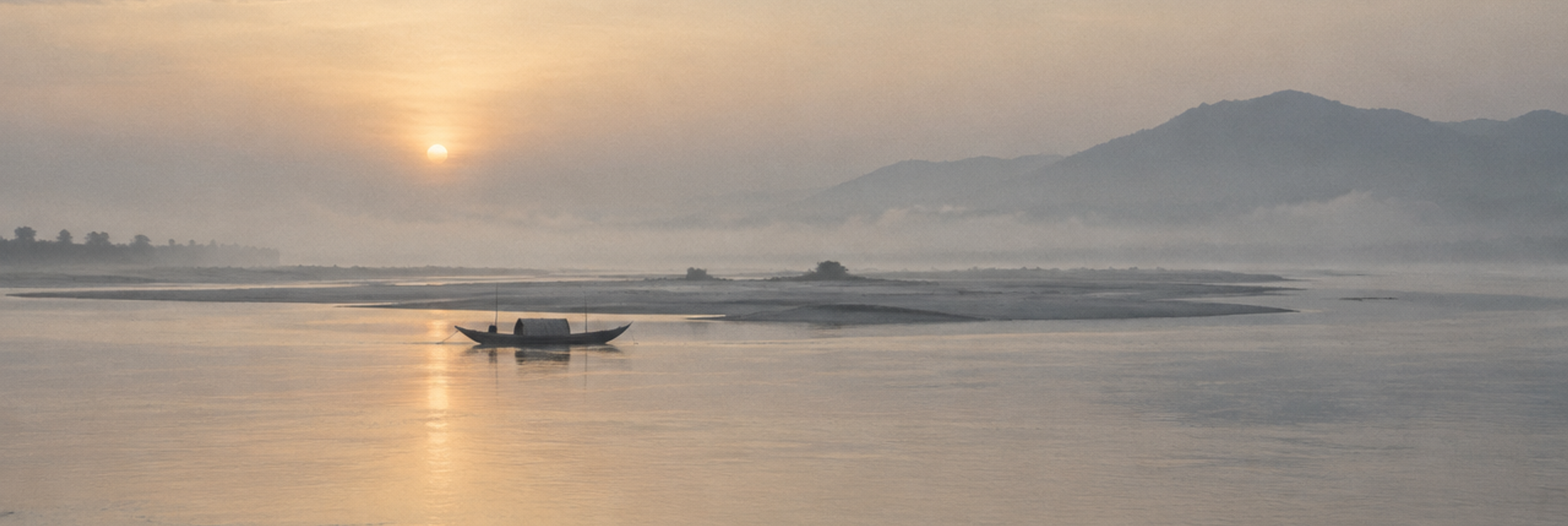 Serene misty sunrise with a boat on calm water